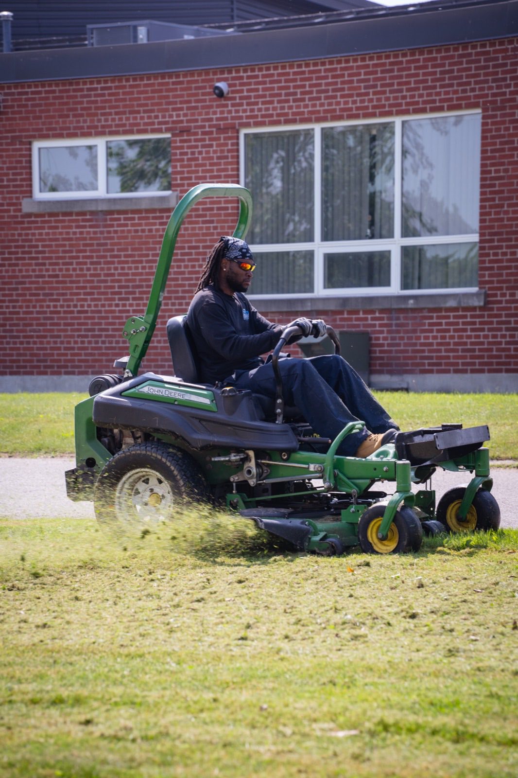 Crew member mowing a commercial property in London, Ontario