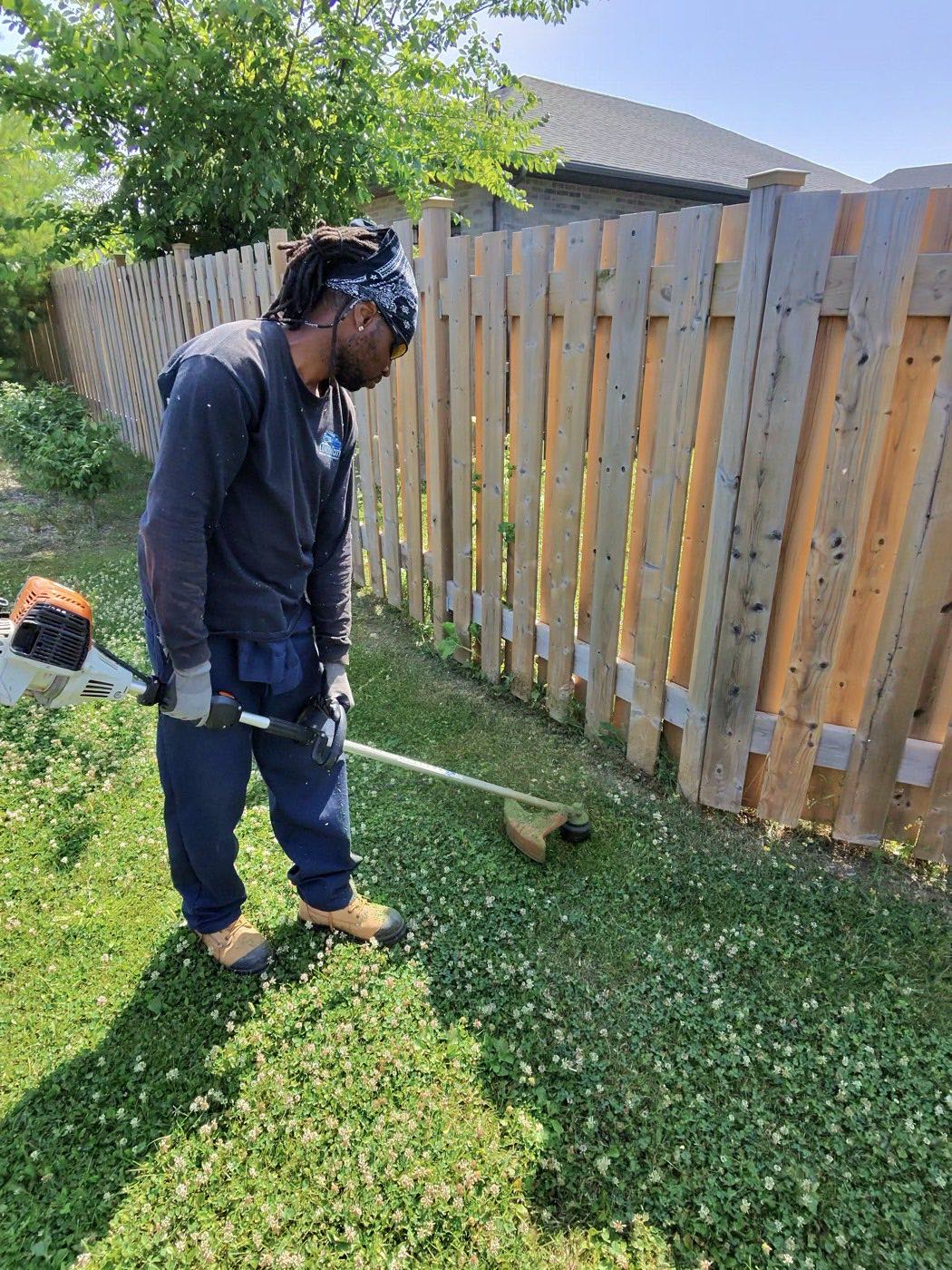 Line trimming along a fence line on a London property